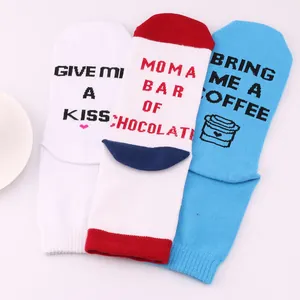 Close-up detail of novelty socks soles with funny English quotes Bring Me A Coffee text