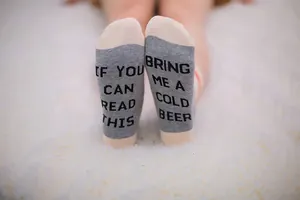 Funny cotton socks detail with 'Bring Me a Cold Beer' text on soles
