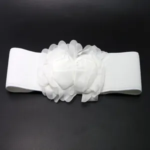 Close-up of elegant white fabric flower decorations on a stretchy elastic waist belt