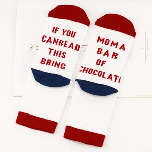 Detailed view of the humorous red letter knitting on white and red cotton socks