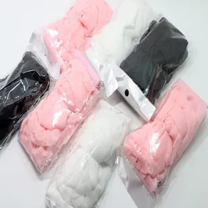 Macro detail view of plus size floral elastic waist belts in pink white and black packaging