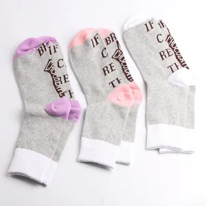 Macro detail view of 'Bring me chocolate' fun message printed on these gray cotton socks