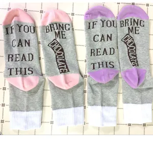 Detail view of funny cotton socks with 'Bring me chocolate' slogan on the soles