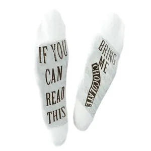 Close-up of funny English message 'Bring me chocolate' on white cotton sock soles