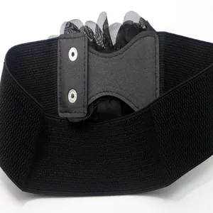 Close-up detail of a wide black elastic corset belt featuring decorative mesh flowers