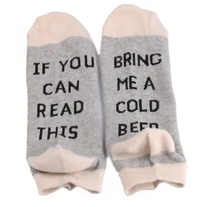Close-up view of grey cotton ankle socks with funny beer drinking text design.