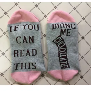 Detailed view of gray and pink funny cotton socks with humorous chocolate message