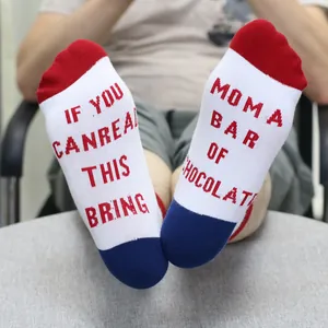 Detail view of funny socks featuring 'If you can read this bring chocolate' printed text