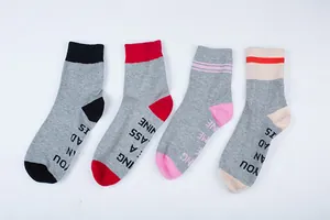Variety of four funny lettered crew socks in grey with black red pink and beige accents