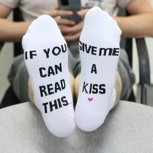 Detailed shot of white novelty socks with 'If you can read this' quote and heart