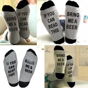 Macro view of funny letter print on grey and black cotton crew socks