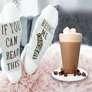 Detailed macro view of white funny socks with Bring Me Chocolate text on the soles