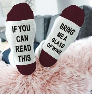 Close-up of funny wine socks with IF YOU CAN READ THIS BRING ME A GLASS OF WINE text