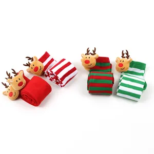 Macro view of festive Christmas over-the-knee socks with striped patterns and reindeer heads