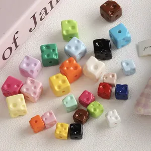 Macro shot of colorful acrylic cheese-shaped beads for DIY jewelry making.
