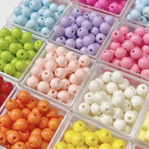 Close-up of macaron colored acrylic round beads in clear containers for DIY jewelry
