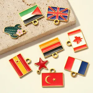 Detailed view of colorful enamel flag charms on a textured neutral stone background