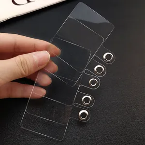 Macro view of multiple transparent phone tether tabs with durable metal grommets for lanyards