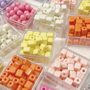 Detail shot of colorful macaron acrylic beads in square and round shapes for DIY.