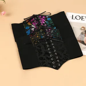 Detail of three black lace-up corset belts with colorful butterfly and star prints