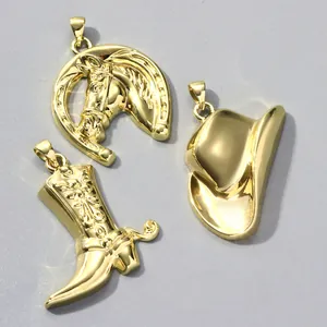 Detailansicht von drei goldenen Western-Cowboy-Anhängern: Hufeisen, Stiefel und Hut