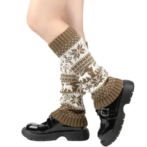 Detail of knitted leg warmers with reindeer and snowflake patterns in brown and white