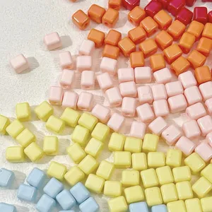 Macro detail of colorful macaron square acrylic beads for DIY jewelry making and phone charms.