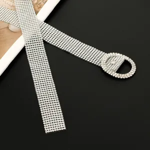 Close-up detail of luxurious full rhinestone belt with sparkling D-shaped buckle for women.