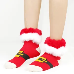 Close-up detail of festive red Christmas socks featuring white furry trim and Santa belt