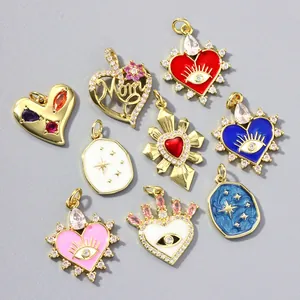 Detailed view of various heart and evil eye pendants with 18k gold plating and zircon stones