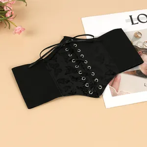 Close-up of black corset belt featuring butterfly print and criss-cross lacing