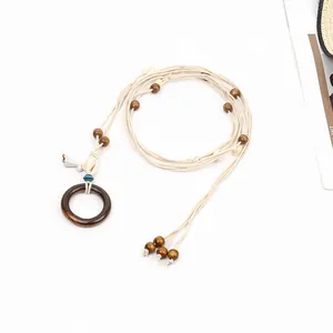 Hand-woven bohemian style waist belt featuring dark wood ring and beads for dress