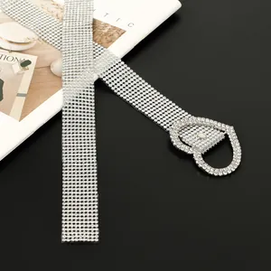 Detailed view of a women's sparkling silver rhinestone belt with heart buckle