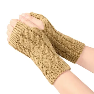 Macro view of khaki cable-knit fingerless gloves showing high-quality warm knit texture