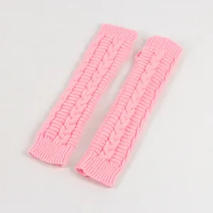 Close-up of pink cable knit fingerless long gloves with thumb hole detail for autumn and winter
