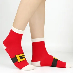 Close-up of red Santa suit Christmas socks with belt design worn on feet