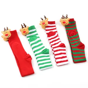 View of four pairs of striped Christmas socks featuring plush reindeer heads at the top band