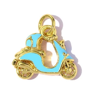 Macro view of a gold-plated scooter jewelry charm with light blue enamel finish decoration
