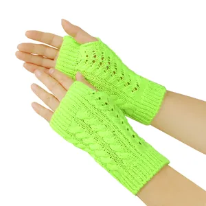 Close-up detail of neon green knitted fingerless gloves with cable knit and hollow design