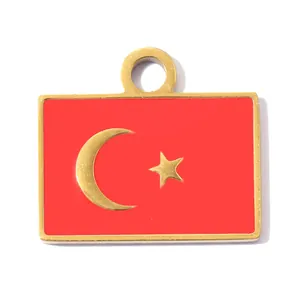 Close-up of a stainless steel pendant featuring the Turkish flag with a red and gold finish.