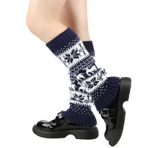 Close-up of navy blue and white knitted leg warmers with snowflake patterns