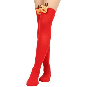 Close-up of festive red over-the-knee Christmas socks with cute plush reindeer decor
