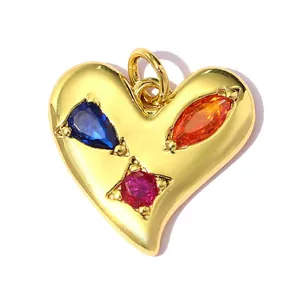Detailed macro shot of 18K gold plated heart pendant featuring three colorful stones.