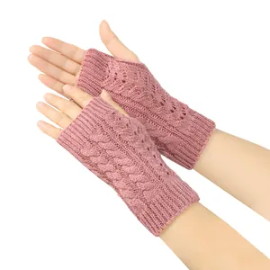 Close-up detail of the pink cable knit and hollow-out pattern on winter fingerless gloves