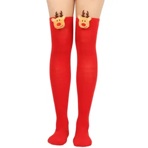 Detailed view of festive red over-the-knee socks with cute plush reindeer heads