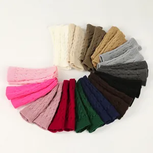 Assortment of colorful cable knit fingerless gloves and warm winter arm warmers.