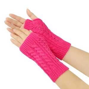 Close-up of bright pink cable knit fingerless gloves with hollowed-out patterns