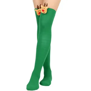 Detail of festive green over-the-knee socks with plush 3D Christmas reindeer heads