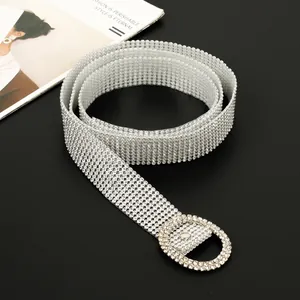 Macro view of luxury full rhinestone belt for women with sparkling silver round buckle detail