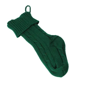 Vue détaillée d'une grande chaussette de Noël en tricot torsadé vert foncé avec boucle